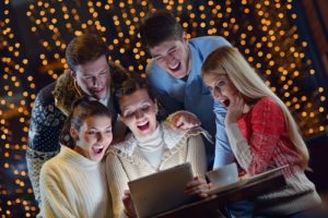 A happy online audience: group of happy people looking at a tablet computer