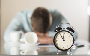 businessman with clock who has no time for marketing