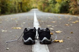 black running shoes on road like marketing marathon for local businesses