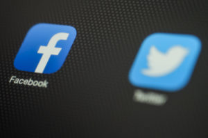 facebook icon on smartphone as user clicks on facebook business page