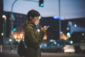 woman on smartphone looking for local business