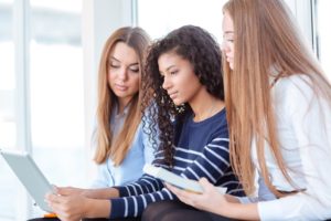 women looking at optimized websites on tablet